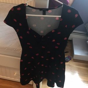 A cute, flirty black dress with lip design!